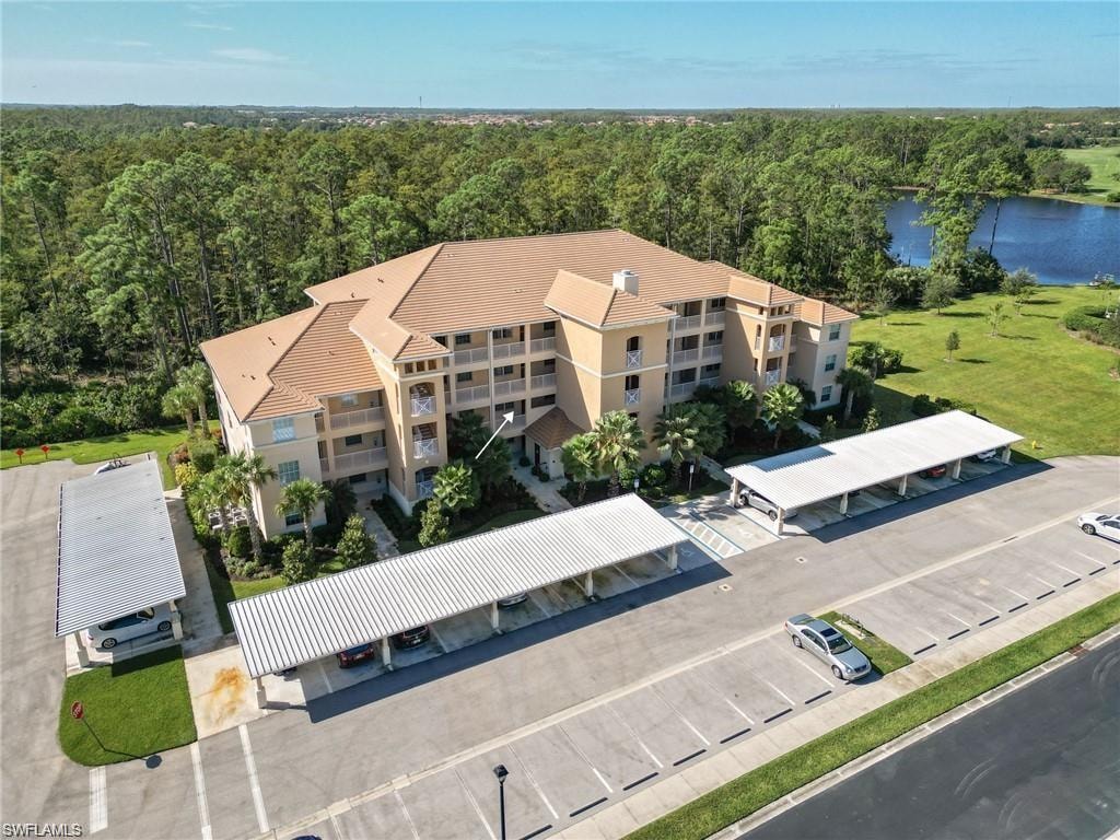 Birds eye view of property with a water view