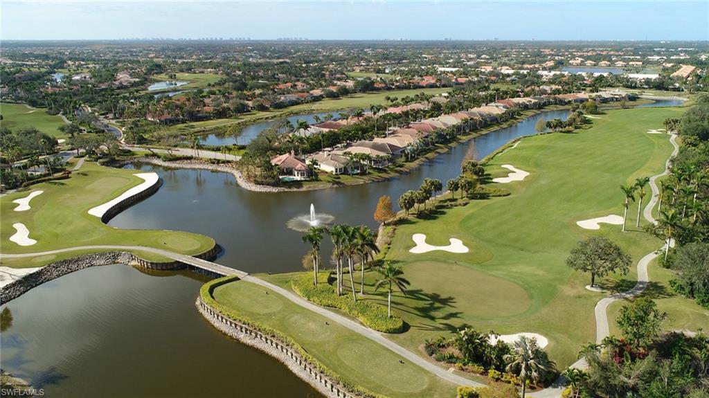 Aerial overview of property's location featuring a golf course and nearby suburban area