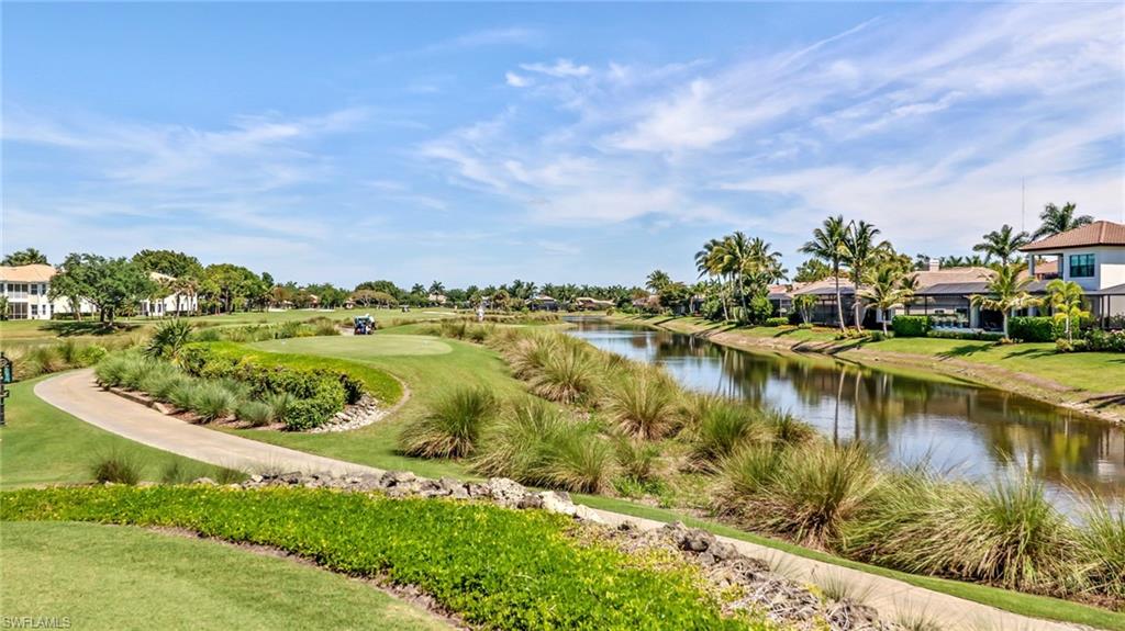 View of property's community with a water view, a residential view, and a yard