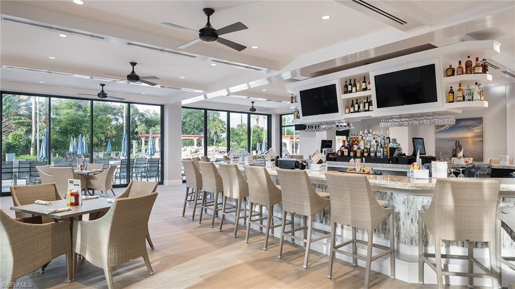 Bar area featuring a ceiling fan and beam ceiling