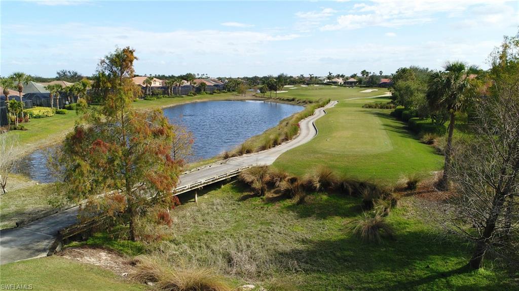 Water view with a golf club and nearby suburban area