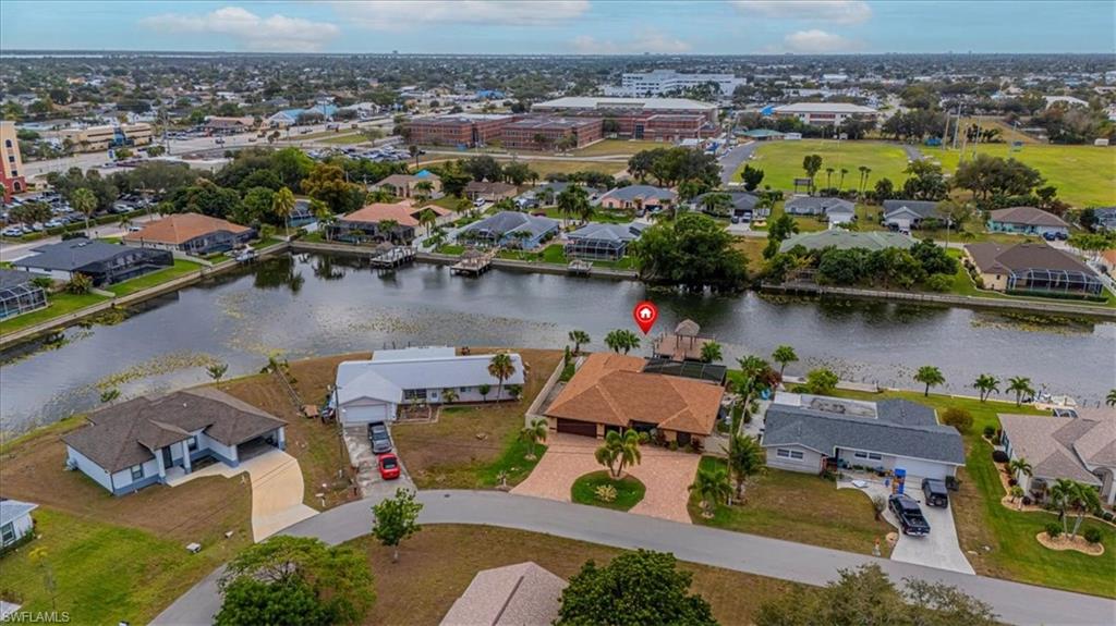 Aerial perspective of suburban area featuring a large body of water