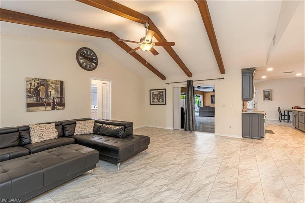 Living room featuring light marble finish floors, a ceiling fan, and recessed lighting
