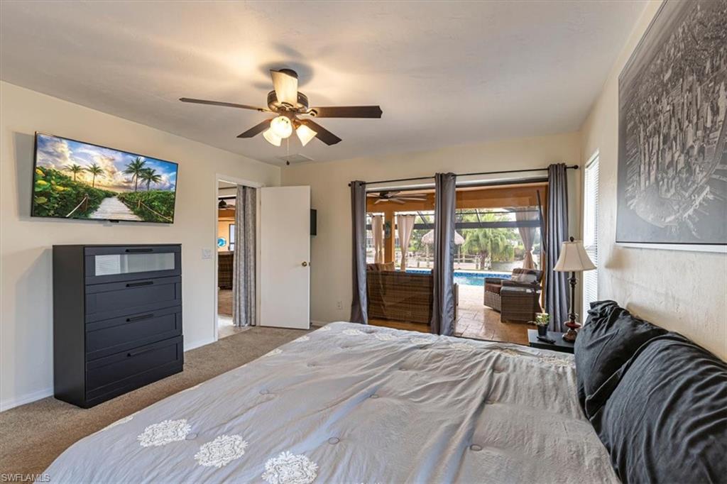 Master Bedroom with carpet, access to outside, and ceiling fan