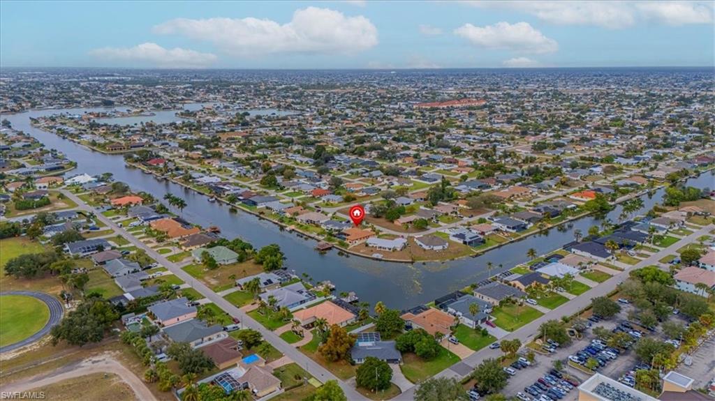 Aerial overview of property's location featuring nearby suburban area and a nearby body of water