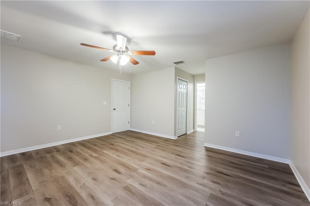 Unfurnished room featuring wood finished floors and ceiling fan