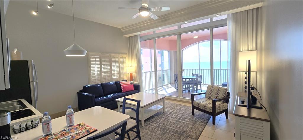 Living room with light tile patterned flooring and a ceiling fan