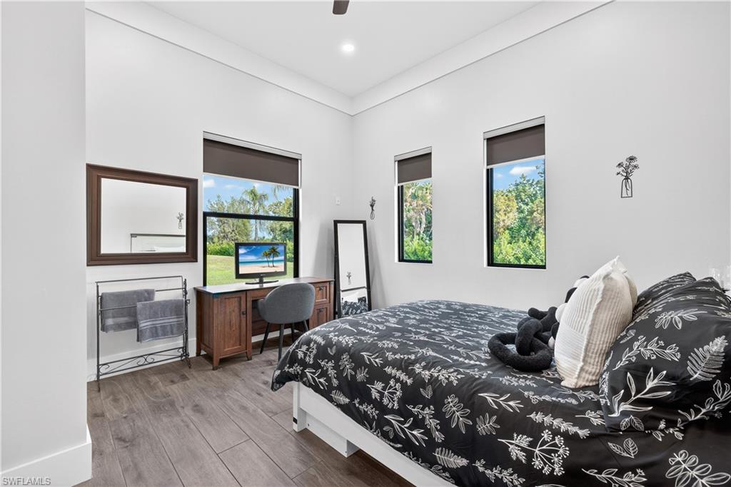 Bedroom with wood finished floors and a ceiling fan