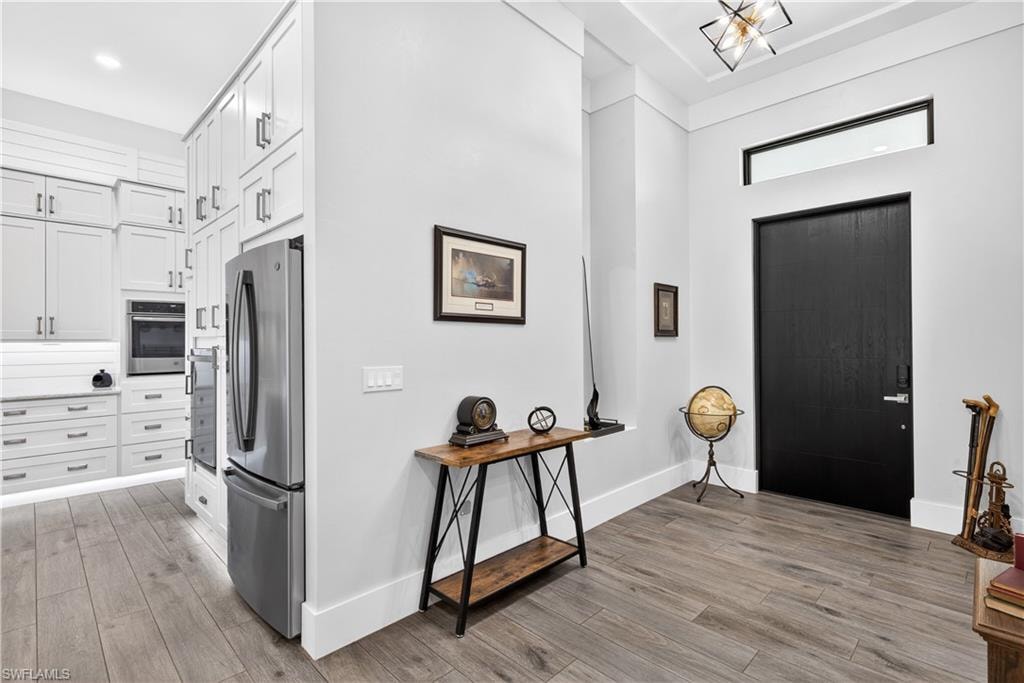 Entryway with a towering ceiling and light wood-style floors