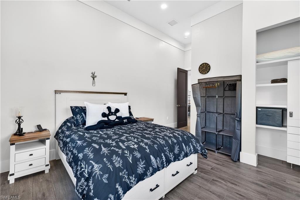 Bedroom with dark wood-type flooring and recessed lighting