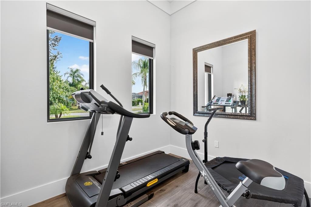 Exercise area featuring wood finished floors and baseboards