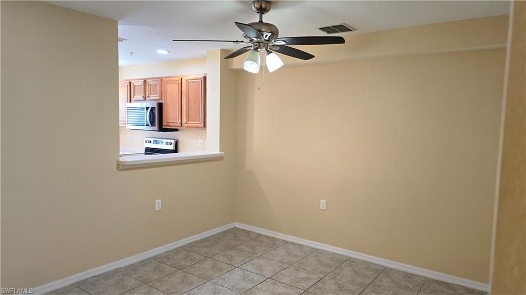 Empty room with light tile patterned flooring, ceiling fan, and recessed lighting