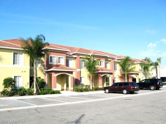 View of front of property with uncovered parking and stucco siding