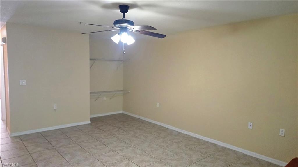 Unfurnished room featuring baseboards and ceiling fan