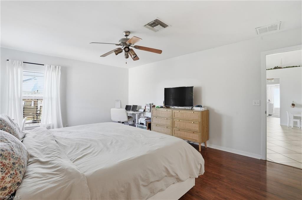 Bedroom featuring dark wood-type flooring and ceiling fan