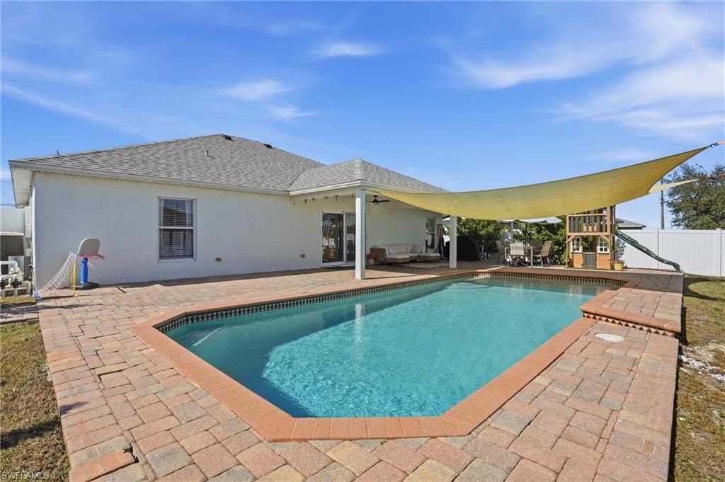 Swimming pool featuring a patio area and a fenced backyard