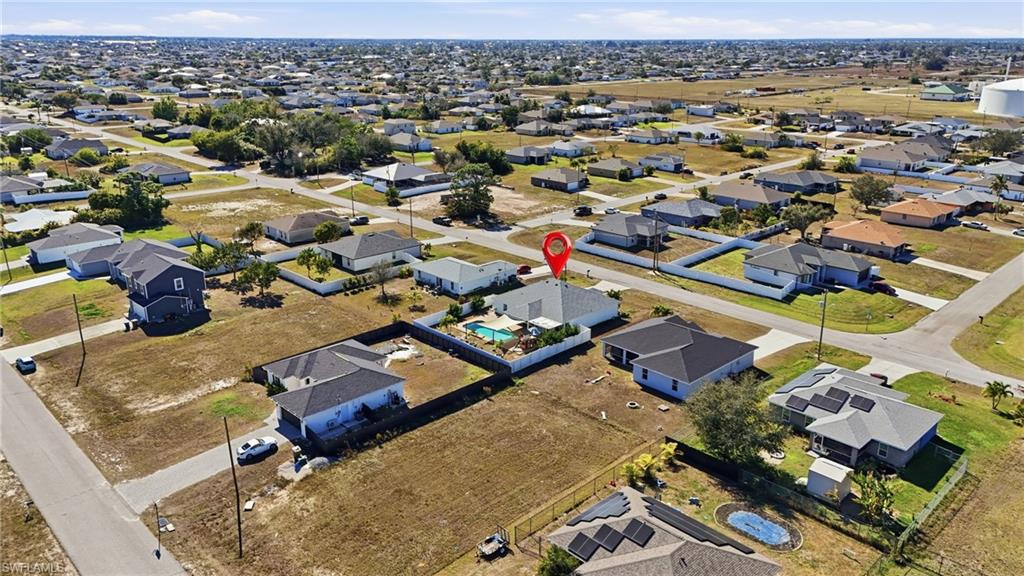 Aerial view of property's location featuring nearby suburban area