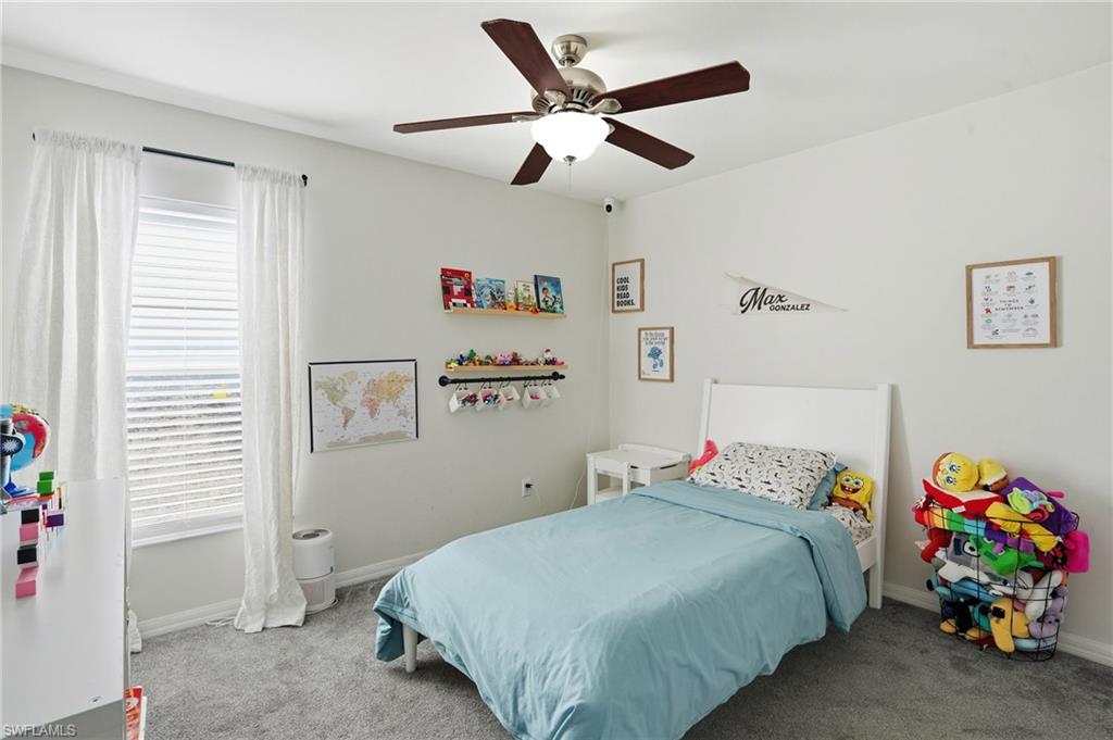 Bedroom with carpet flooring and a ceiling fan