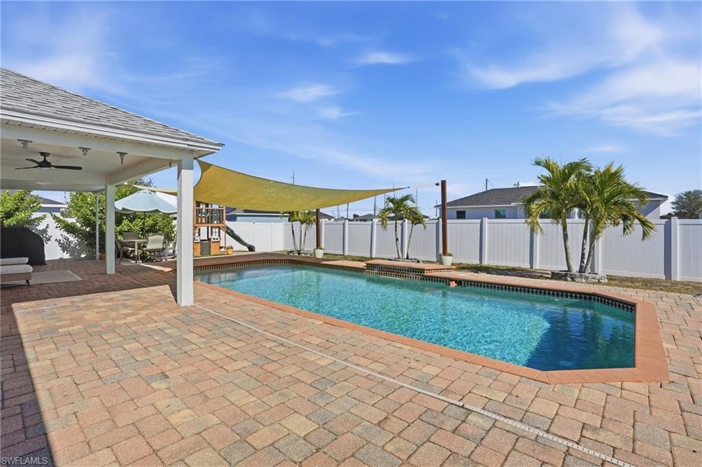 View of pool featuring a patio area and a fenced backyard