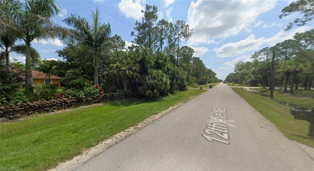 Road view with luxury homes.