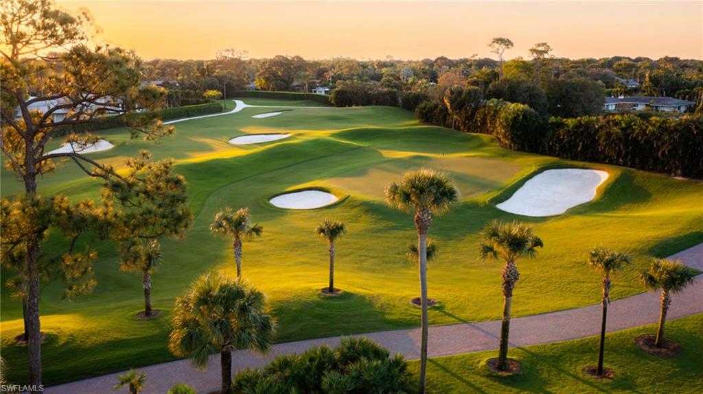 View of property's community with view of golf course and view of scattered trees