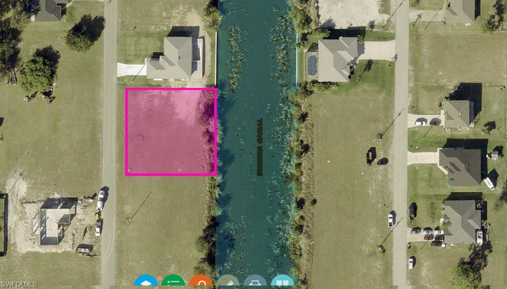 Aerial overview of property's location with a nearby body of water and property boundaries highlighted