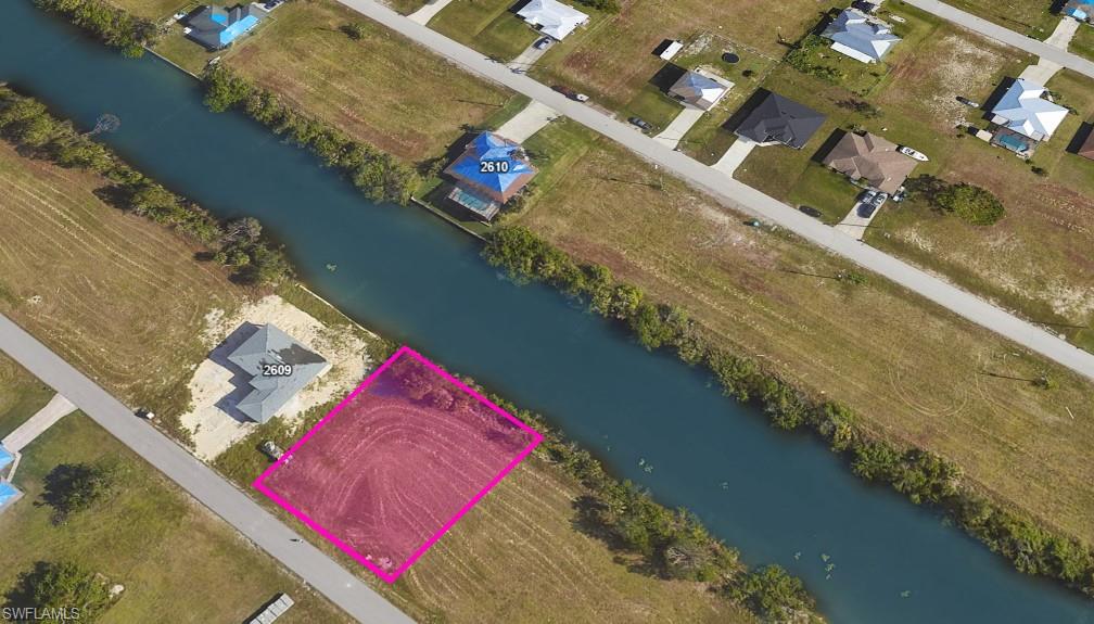 View of property location featuring a nearby body of water and property parcel outlined