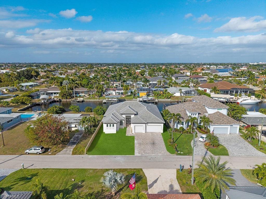 Aerial perspective of suburban area featuring a nearby body of water
