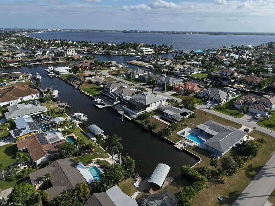 Aerial view of property's location featuring nearby suburban area and a nearby body of water