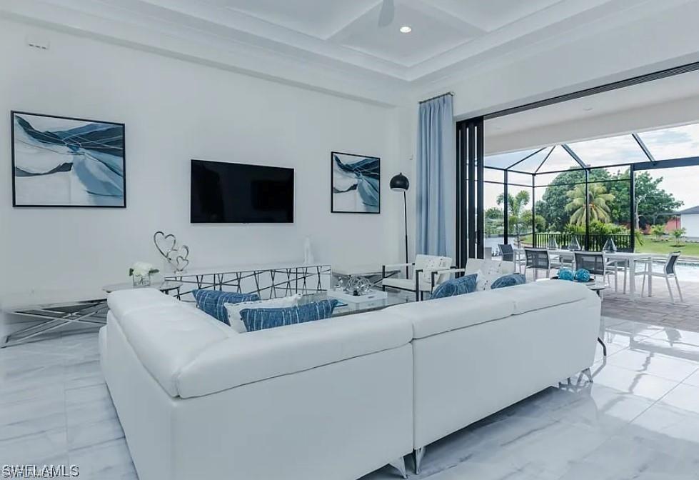 Living room featuring a sunroom, coffered ceiling, marble finish flooring, and beamed ceiling