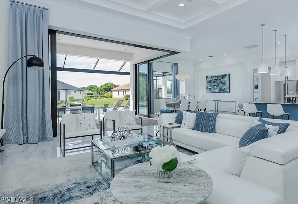 Living room featuring coffered ceiling, beam ceiling, and recessed lighting