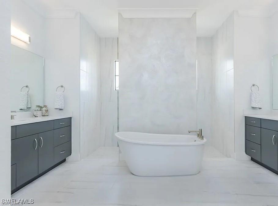 Full bath featuring vanity and a freestanding bath