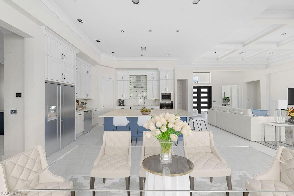 Dining area featuring coffered ceiling, crown molding, beam ceiling, and recessed lighting