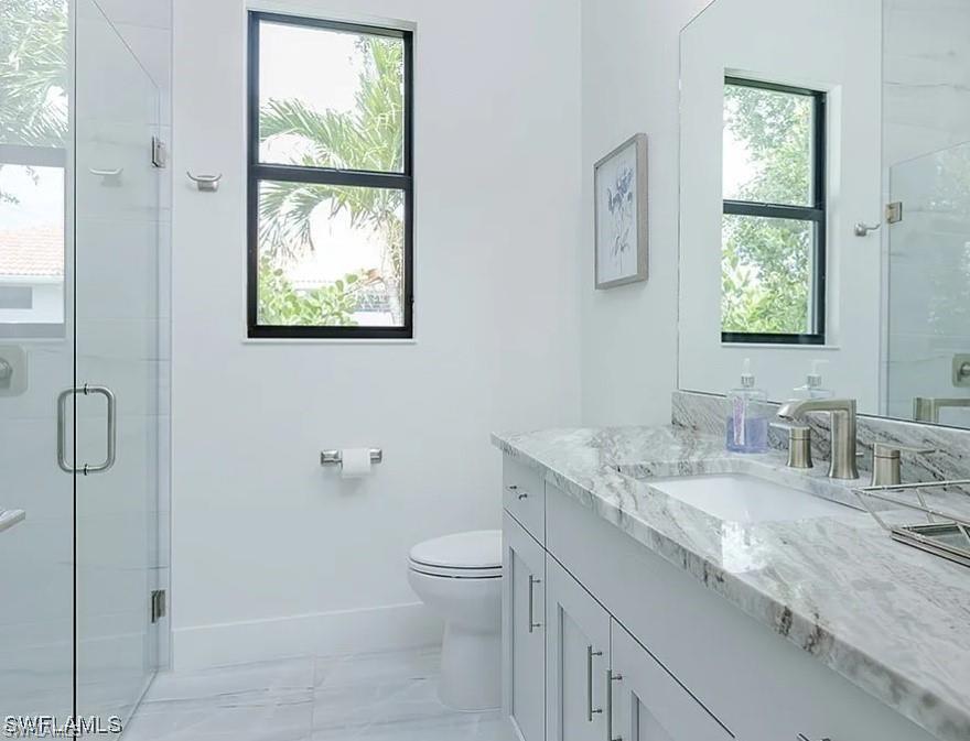 Full bathroom with a shower stall and vanity