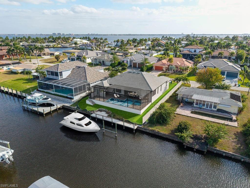 Aerial view of residential area featuring a nearby body of water