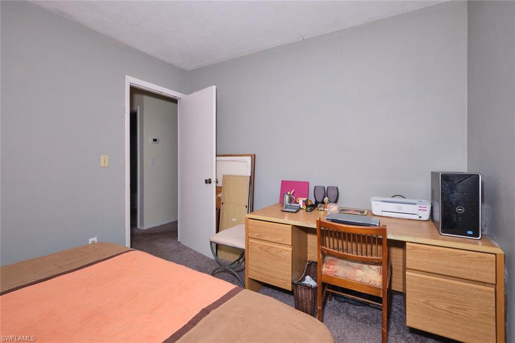Bedroom featuring carpet flooring and an office area