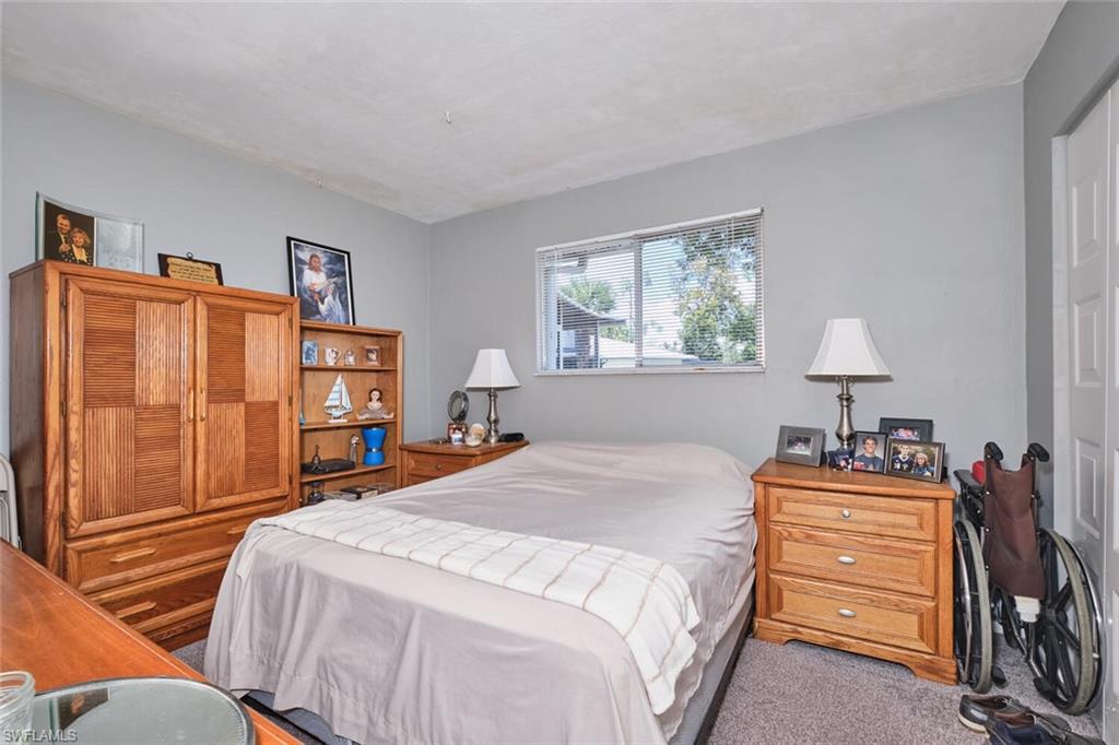 Bedroom featuring light carpet