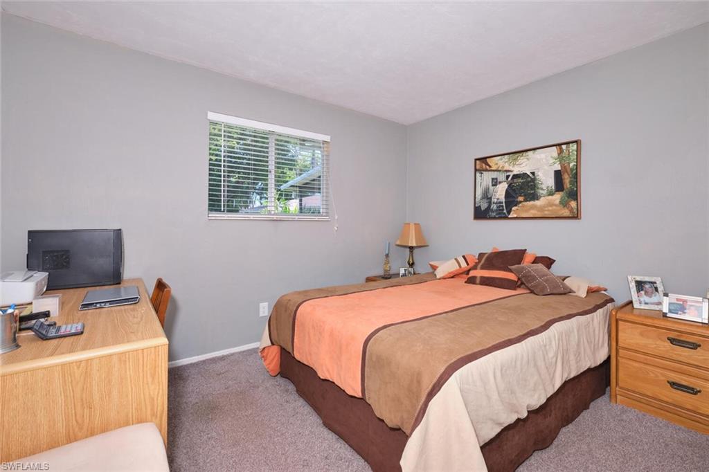 Carpeted bedroom featuring baseboards
