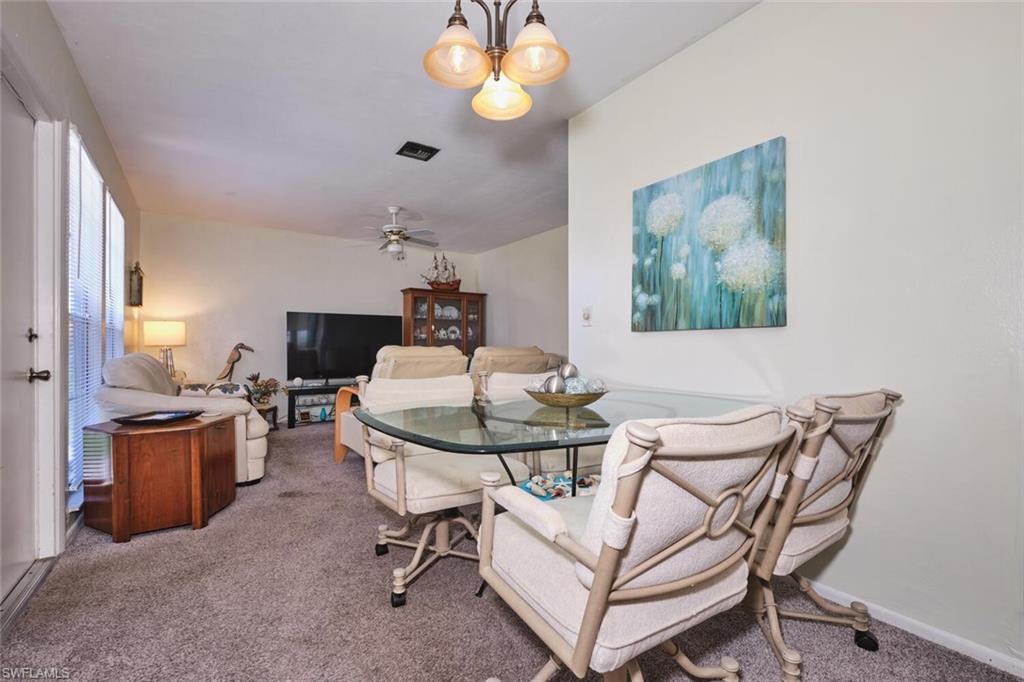 Dining area with carpet flooring, ceiling fan, and baseboards