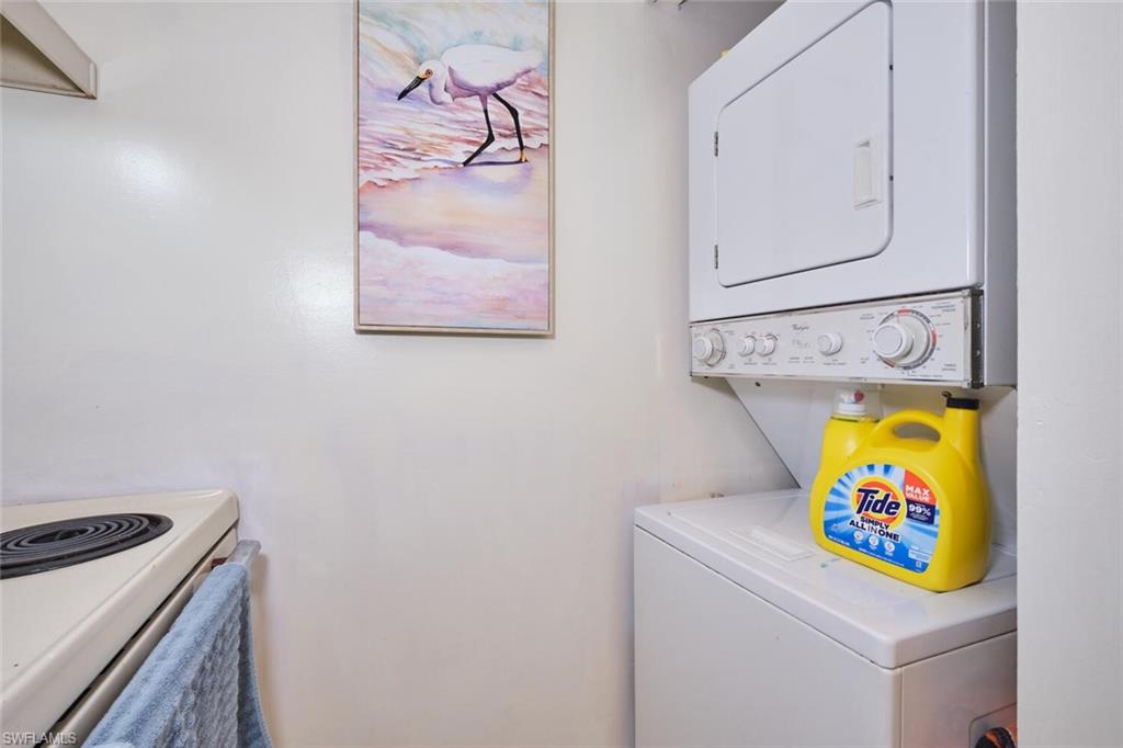 Laundry area with stacked washing machine and dryer