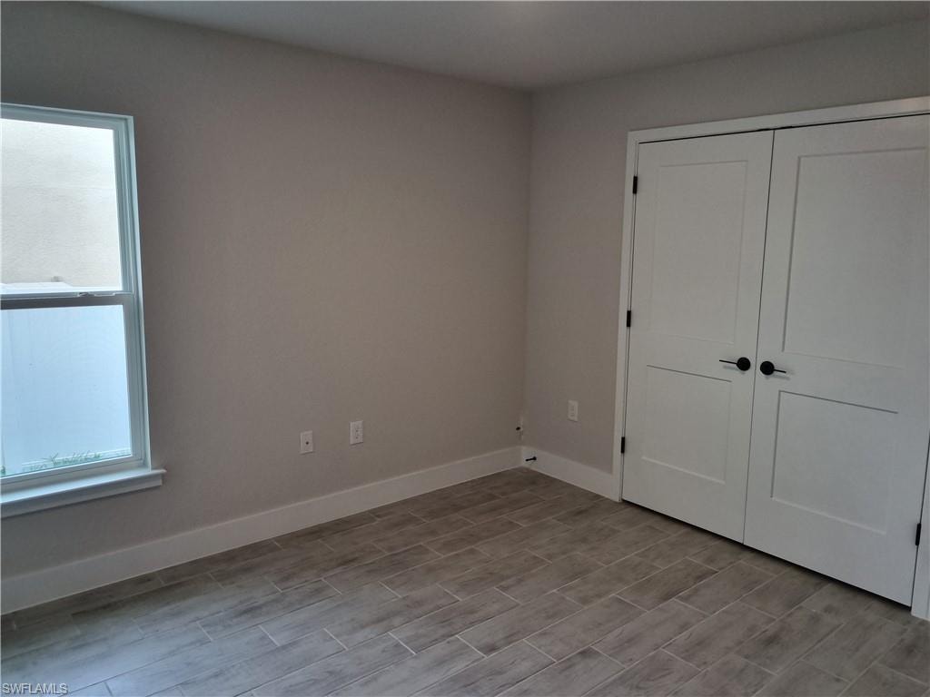 Unfurnished bedroom with baseboards and a closet