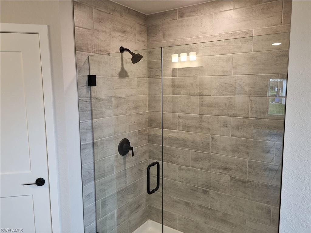 Full bath featuring a shower stall