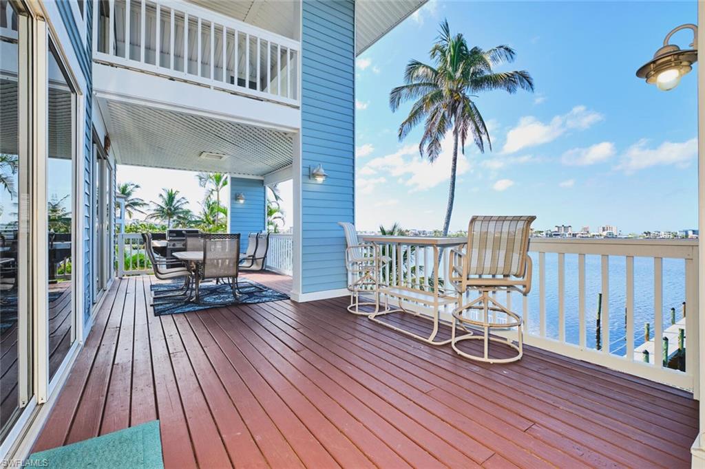 Main living area -  Deck featuring outdoor dining area and a water view