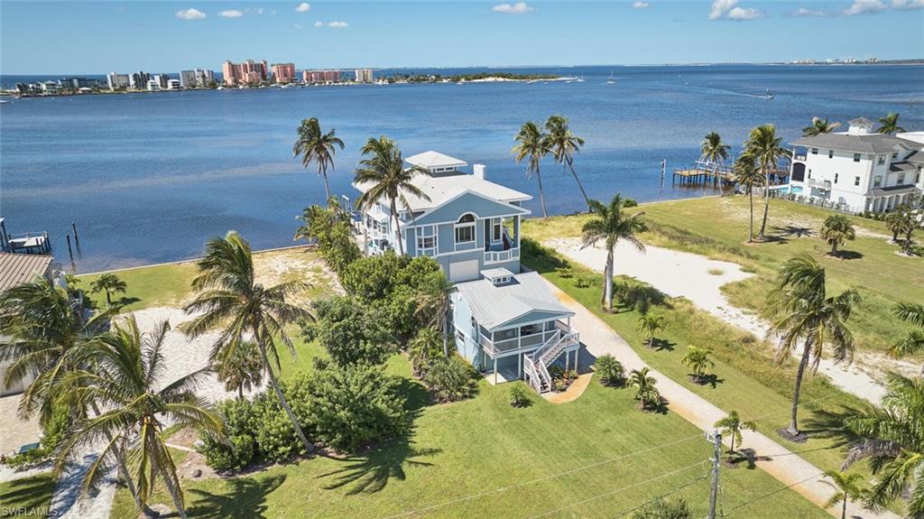 Aerial view of property and surrounding area featuring a nearby body of water