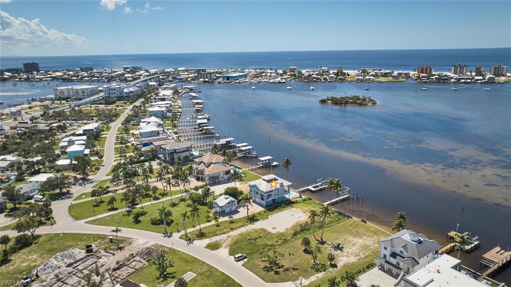 Aerial view of property's location featuring nearby suburban area and a nearby body of water