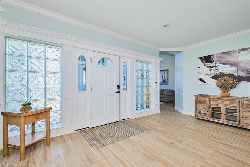 Foyer entrance on second level - main entry - featuring ornamental molding and light wood-style floors