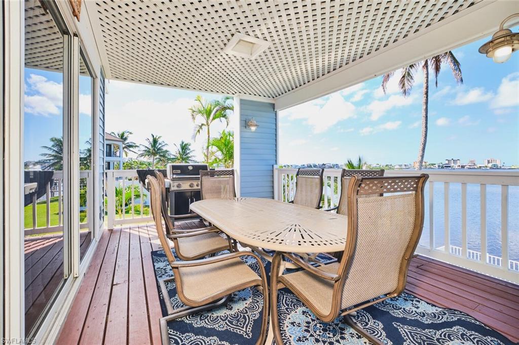 Main living area - Wooden deck featuring a water view and area for grilling