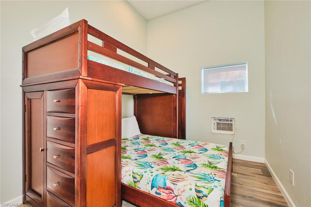 Bedroom 1 of apartment on first  level with baseboards and light wood finished floors