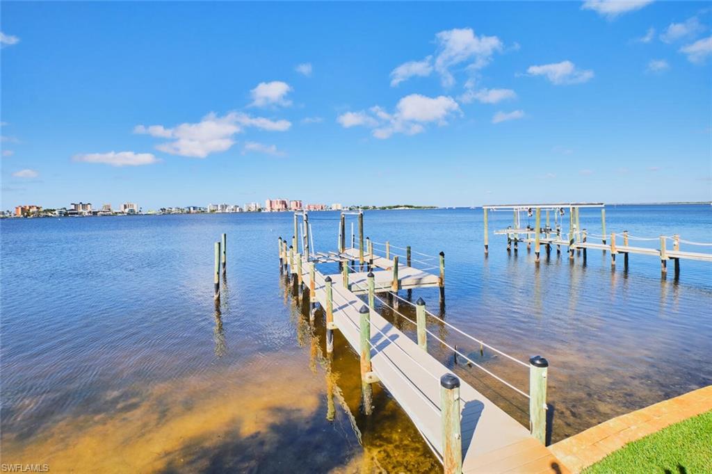 Dock area featuring boat lift and a water view