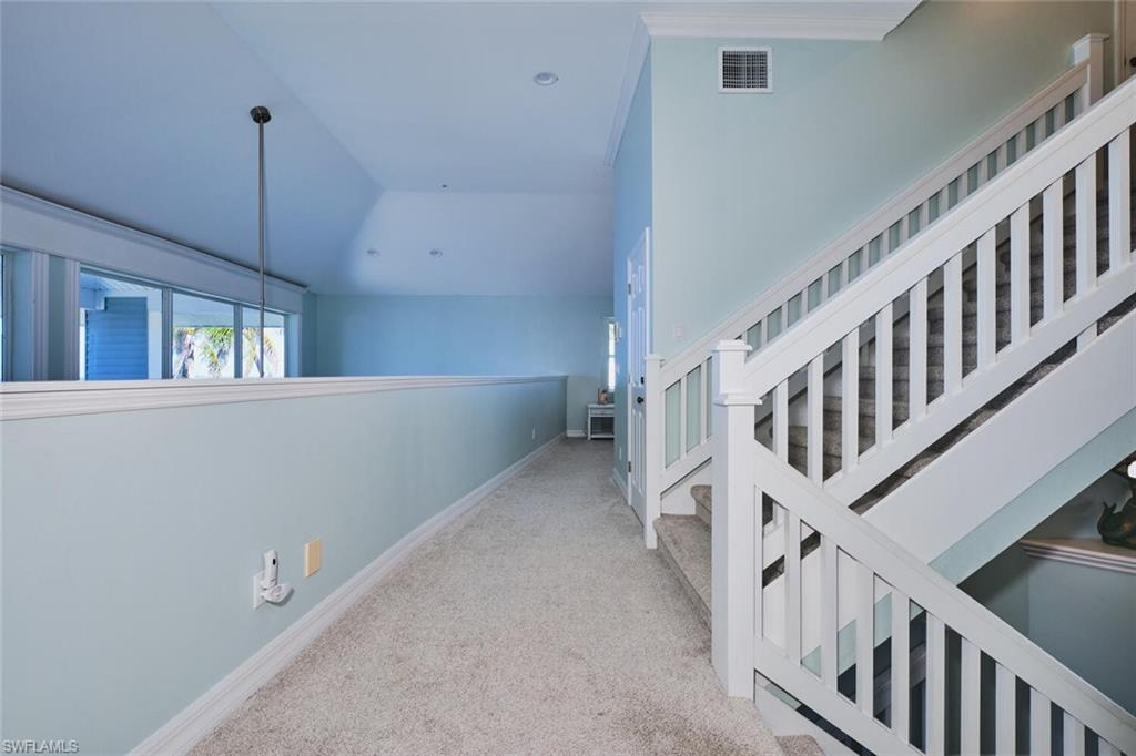 Second Floor Corridor with light carpet and lofted ceiling